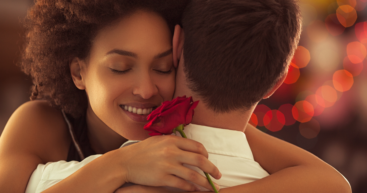 girl hugging her valentine while holding a rose