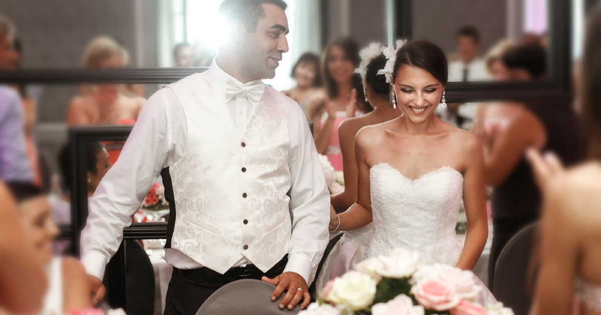 A bride and groom standing for the speeches