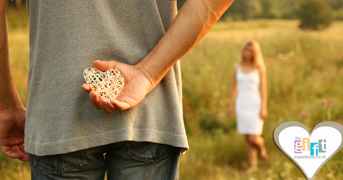 A couple on their first wedding anniversary with a paper heart