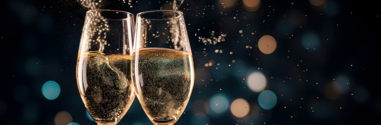 Two champagne glasses clinking in celebration, perfect for anniversary gifts and romantic moments