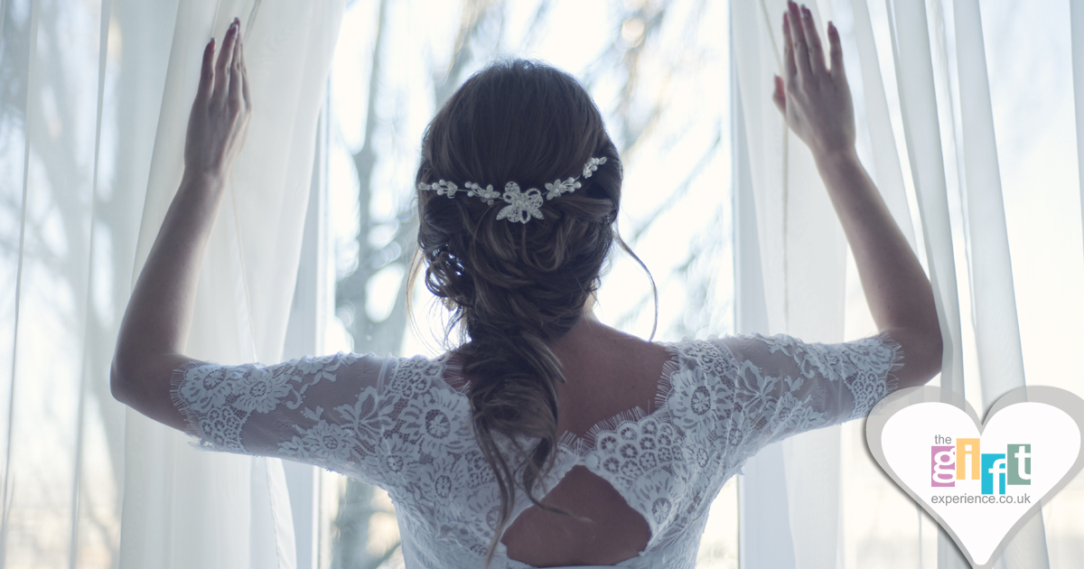 Bride looking out of a window on the morning of her wedding Bride looking out of a window on the morning of her wedding
