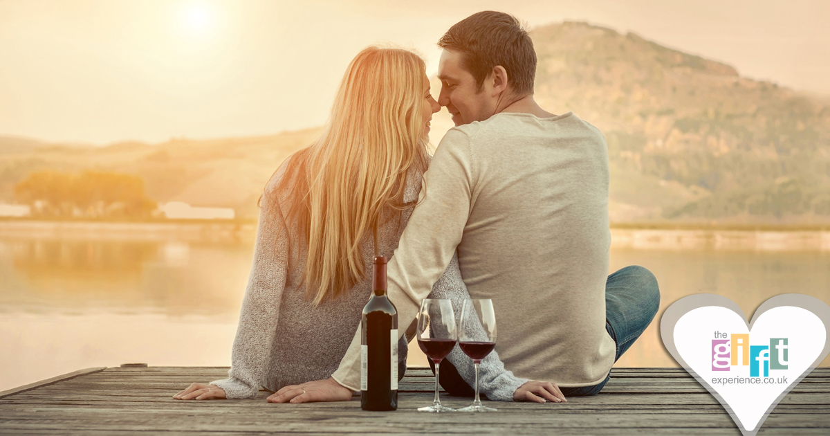 A couple celebrating their wedding anniversary with a good view and a bottle of wine