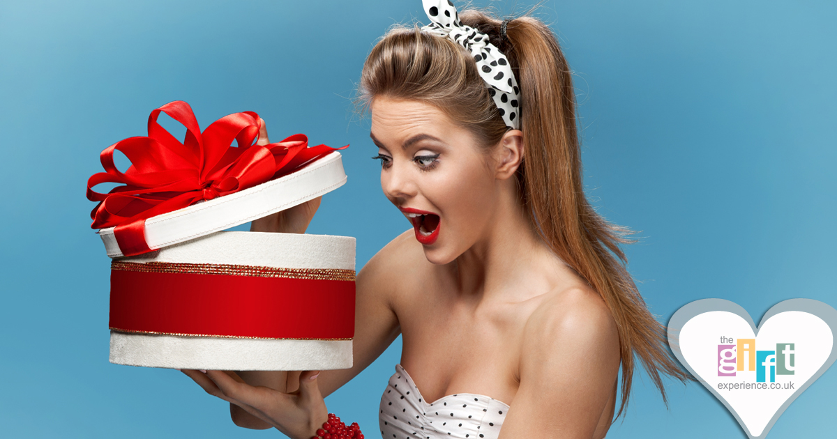woman looking into a gift box woman looking into a gift box