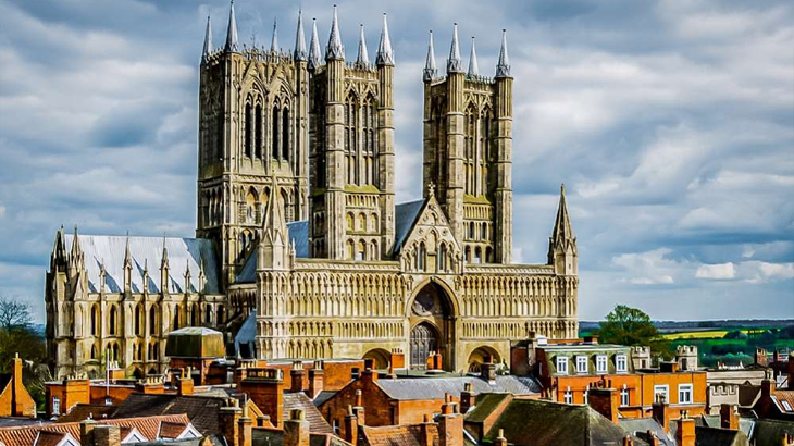 View of Lincoln Cathedral across rooftops, historic town and city escape