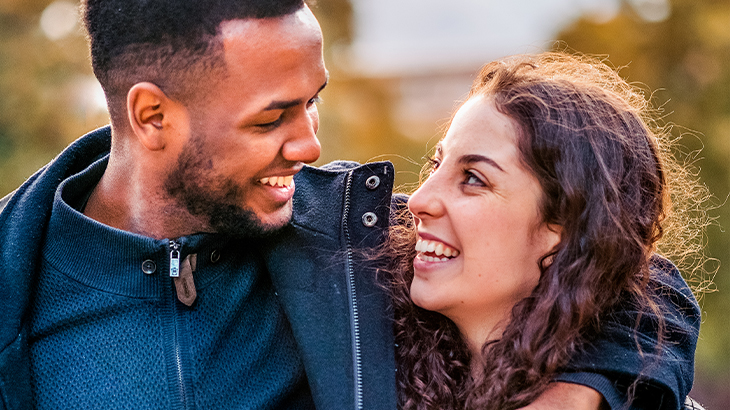 Happy couple looking at each other and having fun, romantic experience gift idea, memorable couple's activity