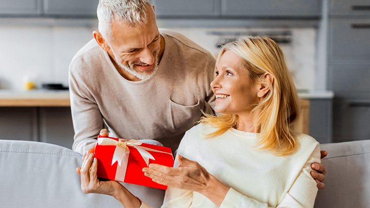 Man giving a thoughtful gift to his wife celebrating 30th wedding anniversary and three decades of love