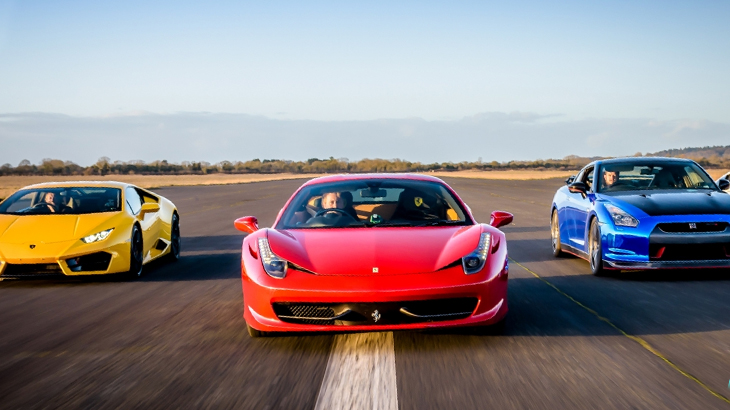 Supercars on a racetrack during a high-speed driving experience including Ferrari and Lamborghini - luxury supercar track day