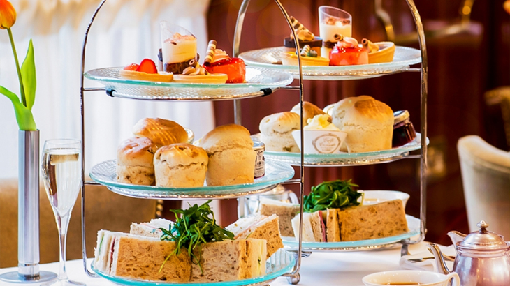 Luxury afternoon tea with pastries, sandwiches, and tea set, perfect for romantic or special occasion experiences