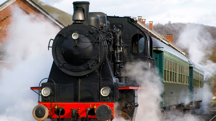 Vintage steam train engulfed in steam, heritage railway journey and scenic train travel experience