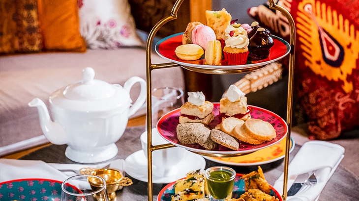 3-tier Indian afternoon tea stand with savoury dishes and desserts, unique fusion dining experience in London
