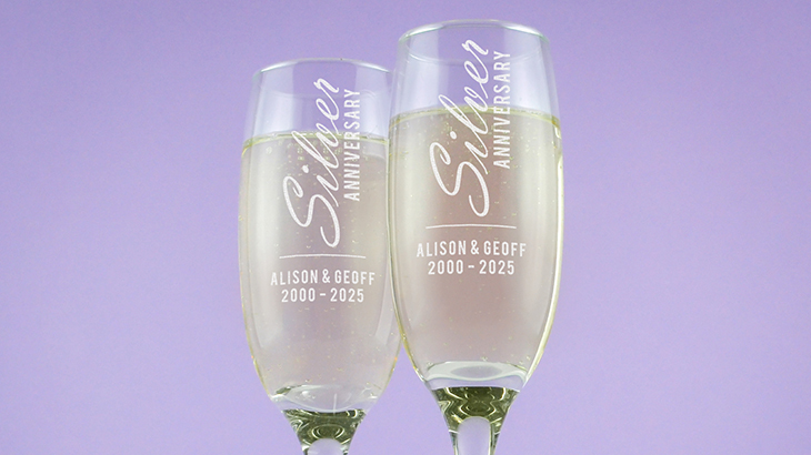 Engraved champagne flutes for a silver anniversary with couple’s names, dates, and elegant design