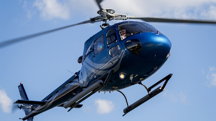 Helicopter flying in the sky as part of an exhilarating gift experience, perfect for anniversary or special occasion adventures