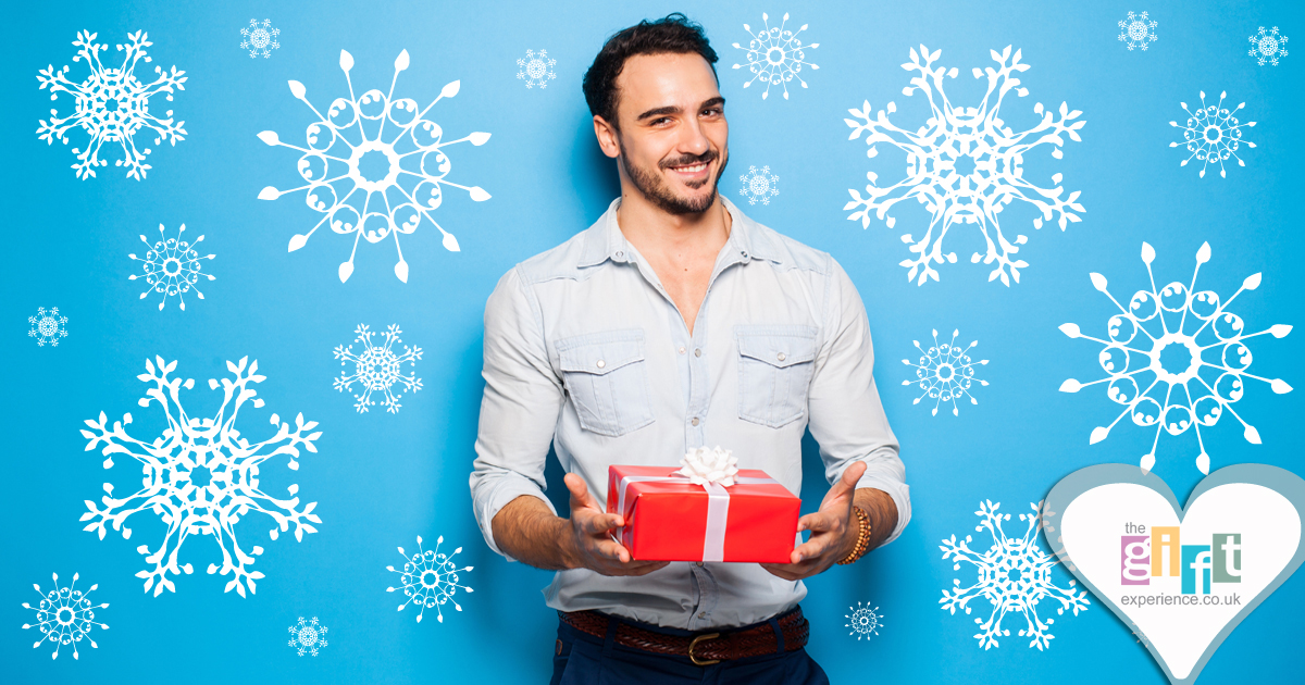 man holding a christmas gift man holding a christmas gift
