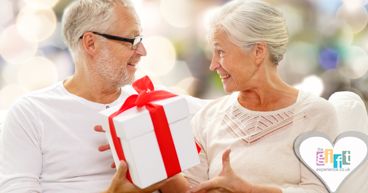a couple celebrating their anniversary by exchanging gifts a couple celebrating their anniversary by exchanging gifts